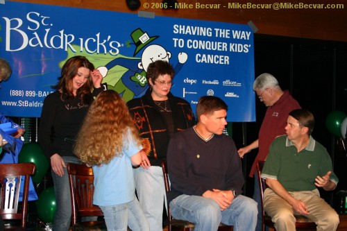 The first group of shavees take their seats.